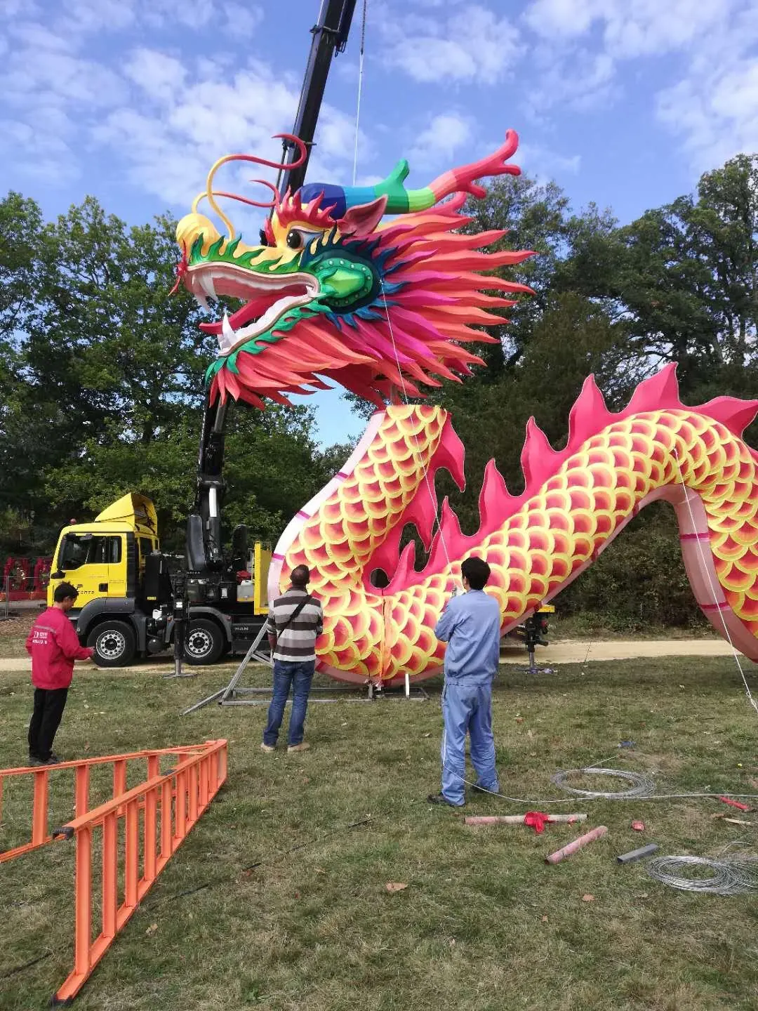 Giant dragon lantern being installed on site by crane and crew