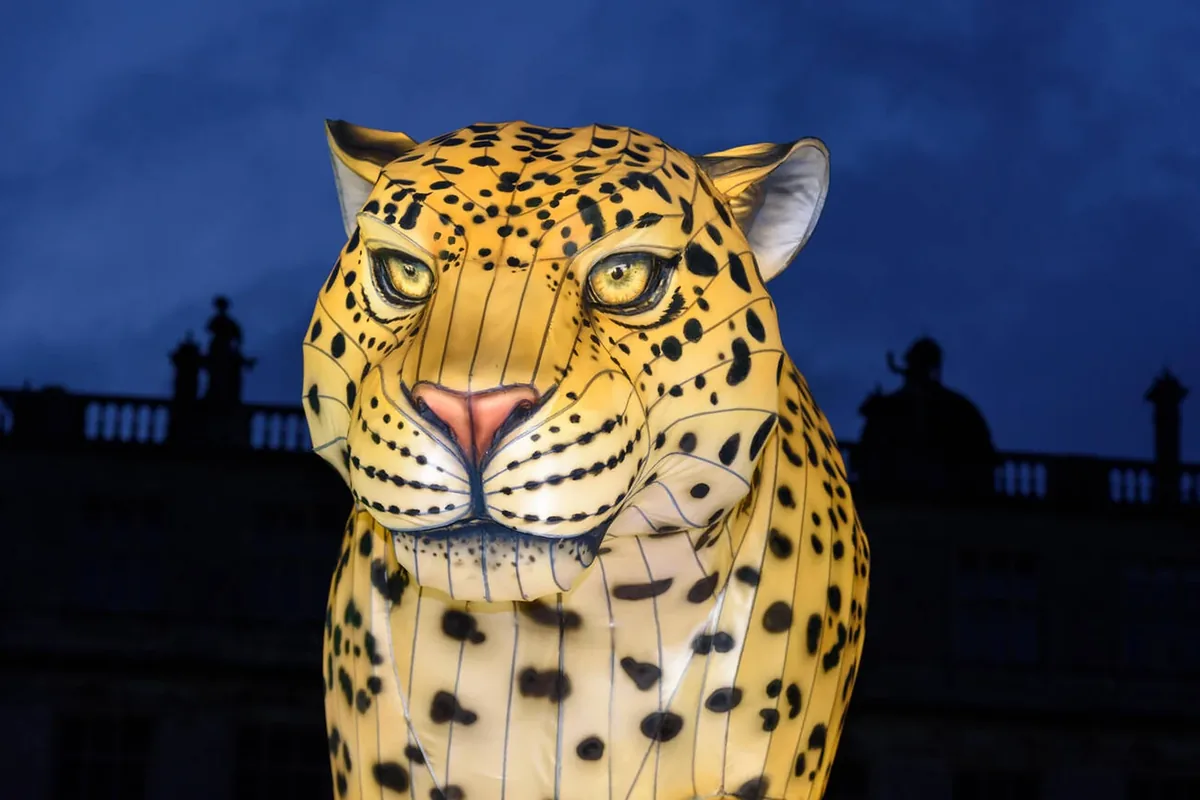 Large leopard lantern sculpture at dusk