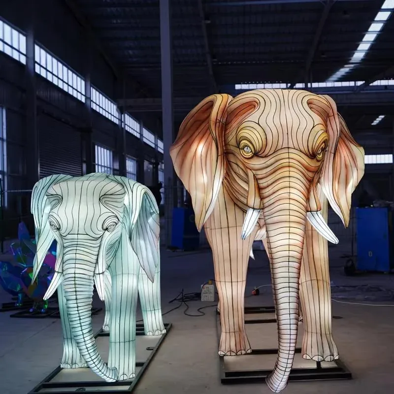 Two illuminated elephant lanterns in the workshop