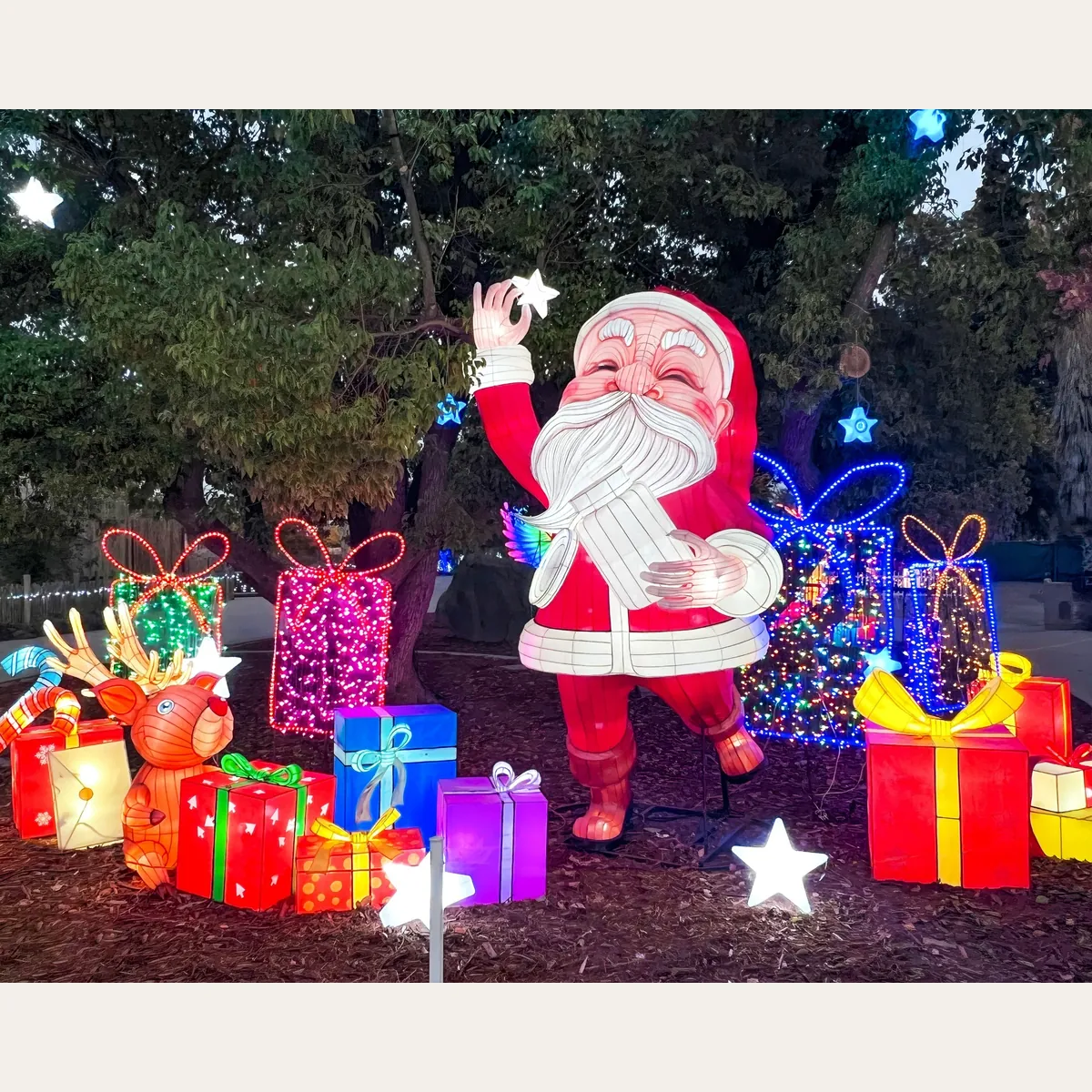 Christmas snowman lanterns with children peeking through